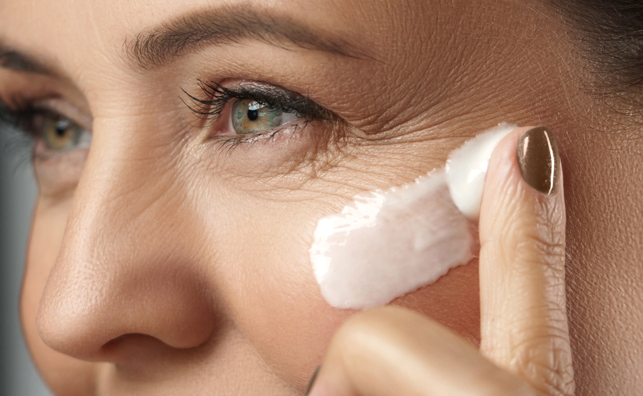 woman passing collagen cream on face